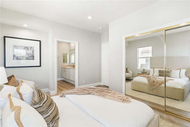 20112 Via Cellini, Porter Ranch, CA 91311 - bedroom featuring a closet, light wood-type flooring, recessed lighting, baseboards, and ensuite bath