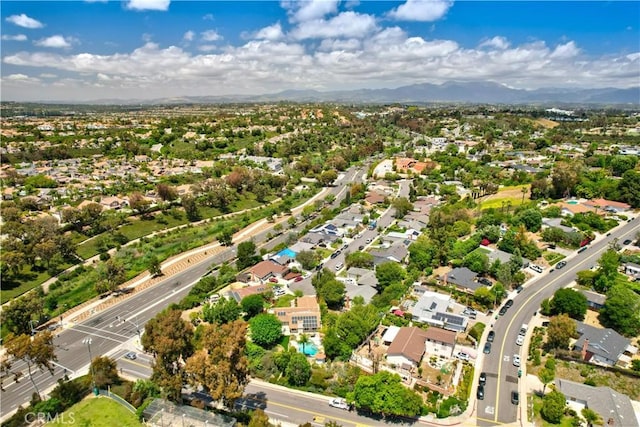 aerial view of property's location featuring nearby suburban area and mountains