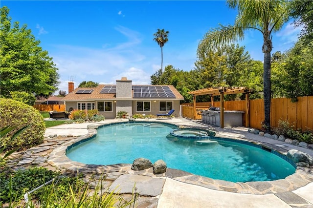 view of pool with a patio area, a fenced backyard, and a pool with connected hot tub