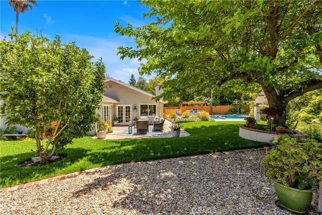 view of yard with french doors, a patio area, and an outdoor living space