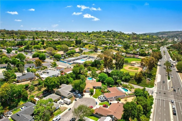 aerial view of property and surrounding area with nearby suburban area