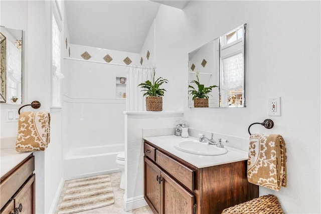 bathroom with vanity, toilet, and bathtub / shower combination