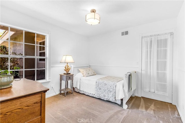 bedroom featuring carpet and baseboards