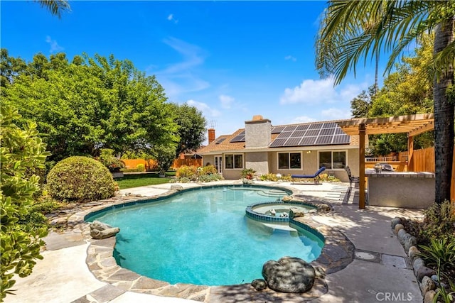 view of swimming pool with a patio, a pool with connected hot tub, and fence