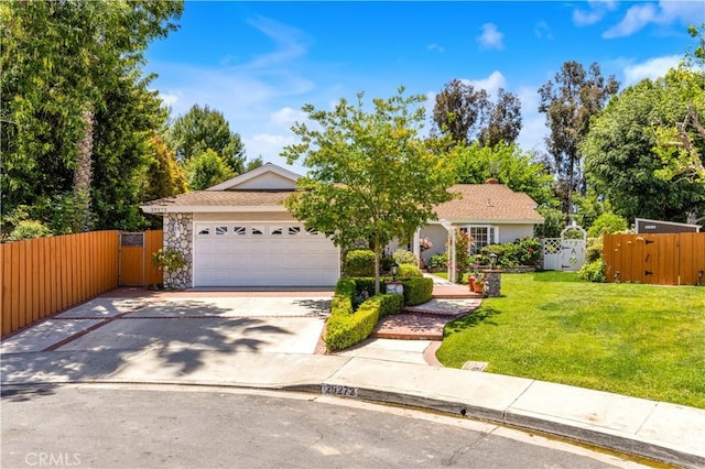 obstructed view of property featuring a gate, concrete driveway, a garage, and stone siding