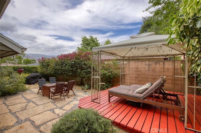 8016 Cora St, Sunland, CA 91040 - view of patio with a fenced backyard, a deck with mountain view, a gazebo, and outdoor dining space