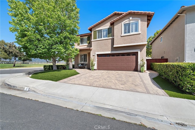 2 Anglesite, Rancho Santa Margarita, CA 92688 - view of front of home featuring a tile roof, an attached garage, stucco siding, and decorative driveway