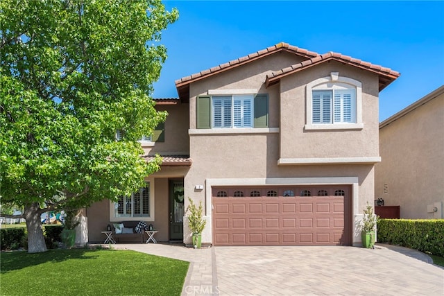 2 Anglesite, Rancho Santa Margarita, CA 92688 - view of front of home featuring decorative driveway, a tile roof, stucco siding, and an attached garage