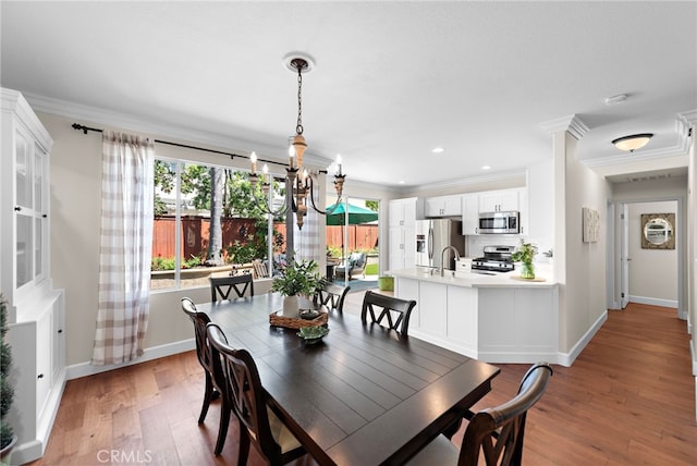 2 Anglesite, Rancho Santa Margarita, CA 92688 - dining room with a chandelier, ornamental molding, wood finished floors, healthy amount of natural light, and baseboards