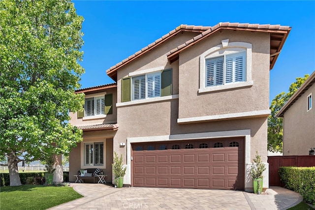 2 Anglesite, Rancho Santa Margarita, CA 92688 - mediterranean / spanish-style house featuring a garage, a tile roof, stucco siding, and driveway