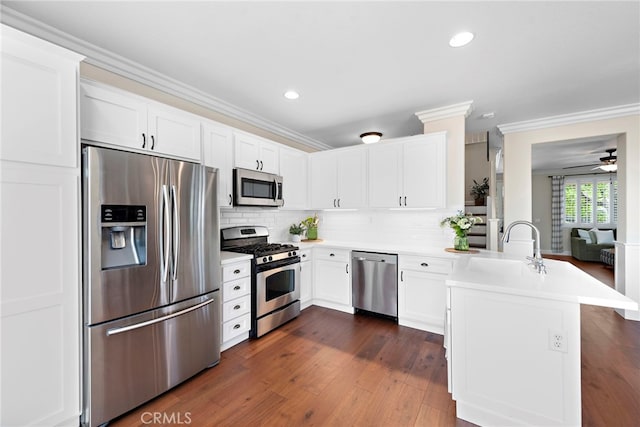 2 Anglesite, Rancho Santa Margarita, CA 92688 - kitchen with appliances with stainless steel finishes, a peninsula, ornamental molding, light countertops, and decorative backsplash