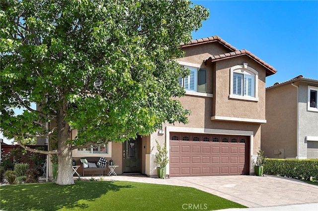 2 Anglesite, Rancho Santa Margarita, CA 92688 - view of front of home with decorative driveway, stucco siding, a garage, and a front lawn