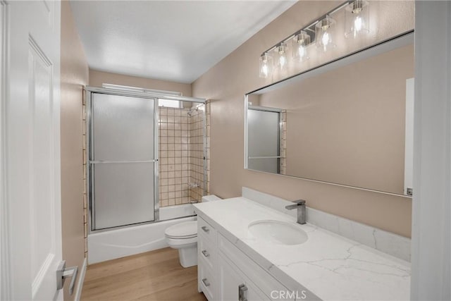 17725 Tude Ln, Apple Valley, CA 92307 - bathroom featuring vanity, toilet, enclosed tub / shower combo, and wood finished floors