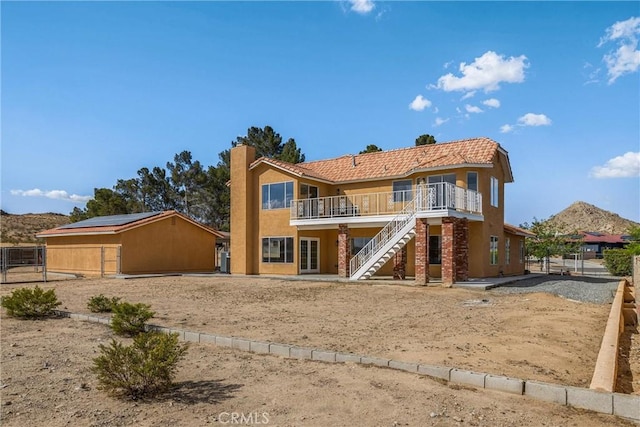 17725 Tude Ln, Apple Valley, CA 92307 - rear view of property featuring stairway, stucco siding, a chimney, and a deck with mountain view
