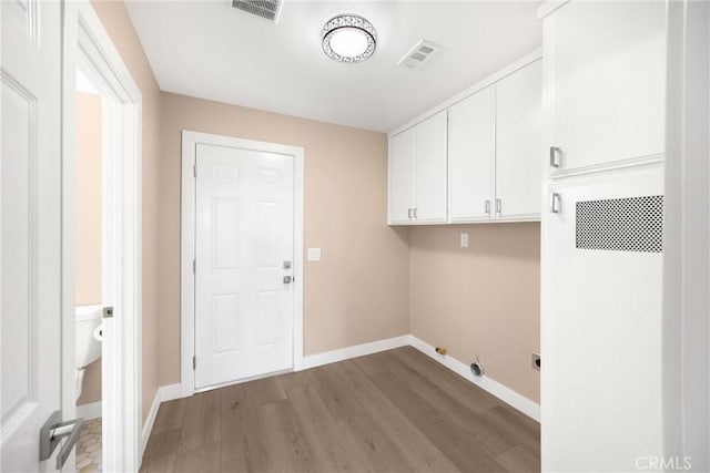 17725 Tude Ln, Apple Valley, CA 92307 - laundry area featuring cabinet space, light wood-type flooring, and baseboards