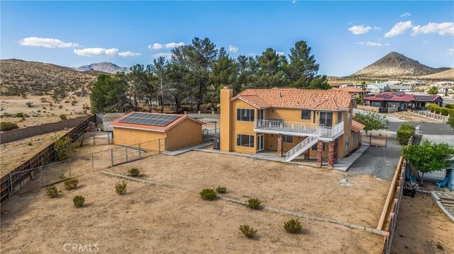 17725 Tude Ln, Apple Valley, CA 92307 - rear view of house with a fenced backyard, stairway, a deck with mountain view, a tiled roof, and stucco siding