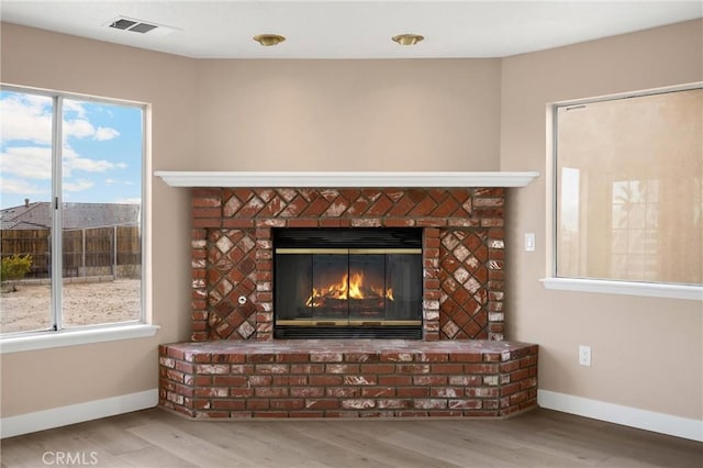 17725 Tude Ln, Apple Valley, CA 92307 - detailed view of a fireplace, baseboards, and wood finished floors
