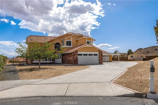 17725 Tude Ln, Apple Valley, CA 92307 - view of front of home with stucco siding, concrete driveway, a tile roof, and an attached garage