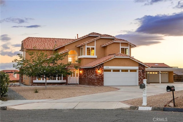 17725 Tude Ln, Apple Valley, CA 92307 - mediterranean / spanish home featuring driveway, a tile roof, and stucco siding