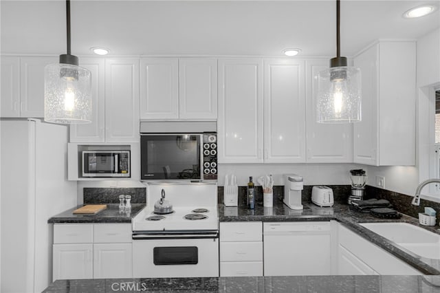 74216 Myrsine Ave, Palm Desert, CA 92260 - kitchen featuring white appliances, a sink, white cabinetry, decorative light fixtures, and dark stone countertops