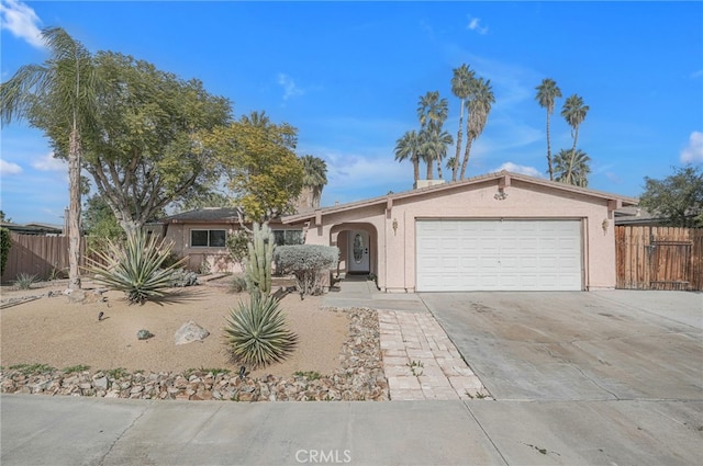 74216 Myrsine Ave, Palm Desert, CA 92260 - ranch-style house featuring driveway, fence, a garage, and stucco siding