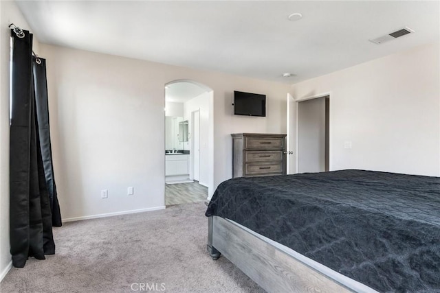 1113 Juniper Ct, San Jacinto, CA 92582 - carpeted bedroom featuring arched walkways, baseboards, and ensuite bathroom