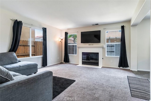 1113 Juniper Ct, San Jacinto, CA 92582 - carpeted living area featuring a fireplace with flush hearth and baseboards