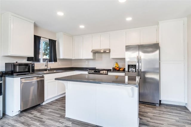 1113 Juniper Ct, San Jacinto, CA 92582 - kitchen featuring stainless steel appliances, dark countertops, light wood-type flooring, white cabinets, and recessed lighting