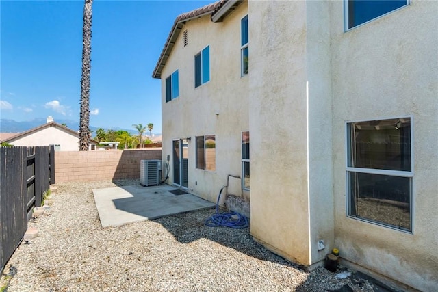 1113 Juniper Ct, San Jacinto, CA 92582 - back of house with stucco siding, a fenced backyard, central air condition unit, and a patio