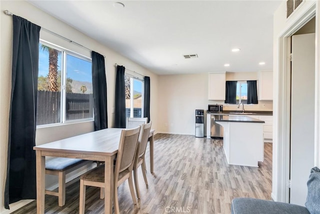 1113 Juniper Ct, San Jacinto, CA 92582 - dining room featuring light wood-style floors, recessed lighting, healthy amount of natural light, and baseboards