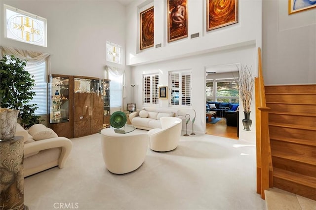 25415 Verne Ct, Stevenson Ranch, CA 91381 - living area with a towering ceiling, stairs, and carpet flooring