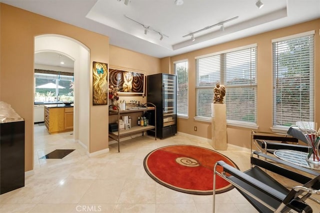25415 Verne Ct, Stevenson Ranch, CA 91381 - sitting room with rail lighting, a raised ceiling, light tile patterned flooring, and baseboards