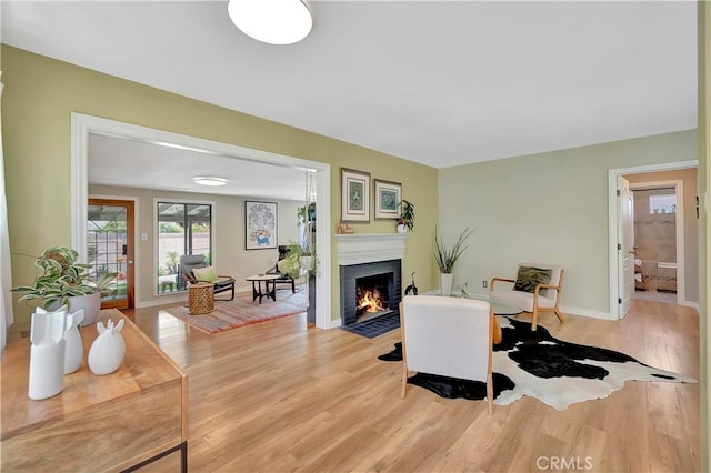 3235 Faust Ave, Long Beach, CA 90808 - living room with light wood-style floors, a fireplace with flush hearth, and baseboards