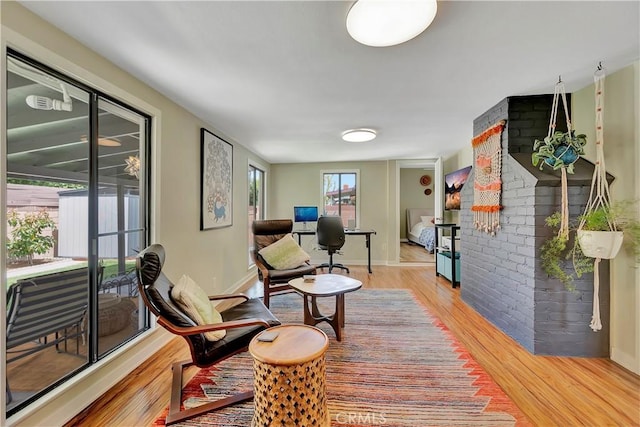 3235 Faust Ave, Long Beach, CA 90808 - sitting room with light wood-type flooring, baseboards, and brick wall