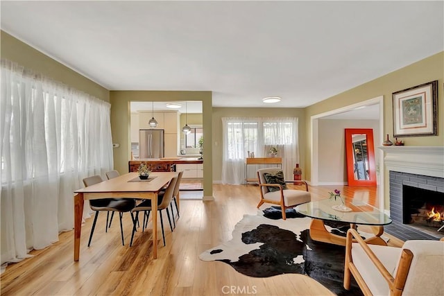 3235 Faust Ave, Long Beach, CA 90808 - dining space featuring light wood-style floors and a brick fireplace