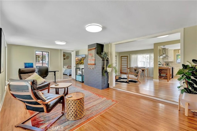 3235 Faust Ave, Long Beach, CA 90808 - living room featuring light wood finished floors, baseboards, and a fireplace