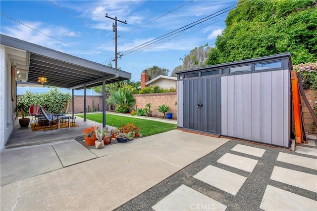 3235 Faust Ave, Long Beach, CA 90808 - view of patio / terrace featuring a storage unit, a fenced backyard, and an outbuilding