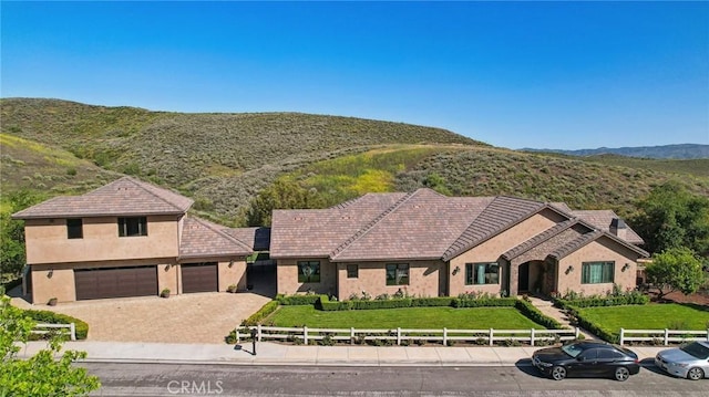 4004 Snowgoose St, Simi Valley, CA 93065 - view of front of property featuring stucco siding, driveway, a garage, and a mountain view