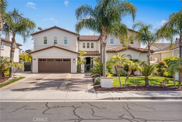 32429 Castle Ct, Temecula, CA 92592 - mediterranean / spanish house with a tile roof, stucco siding, concrete driveway, and a gate