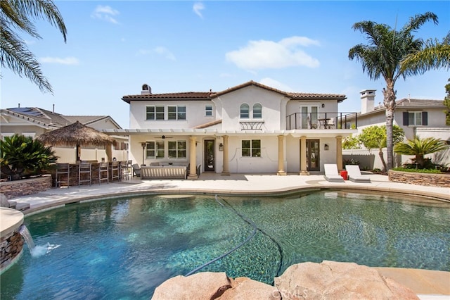 32429 Castle Ct, Temecula, CA 92592 - back of house featuring a balcony, stucco siding, a patio area, a chimney, and a tile roof