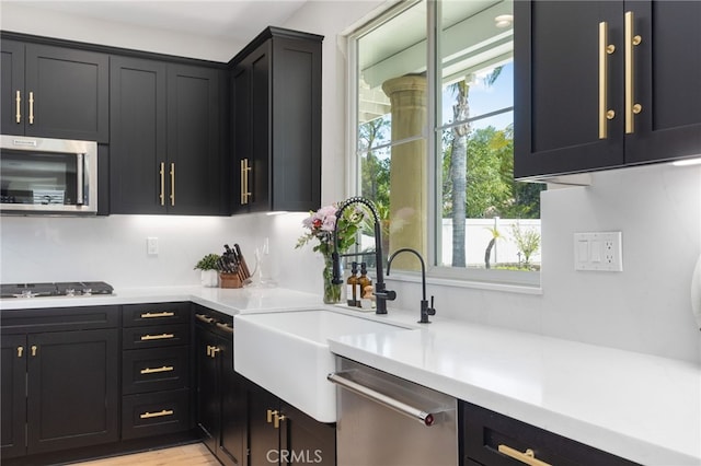 32429 Castle Ct, Temecula, CA 92592 - kitchen with stainless steel appliances, light countertops, and dark cabinets