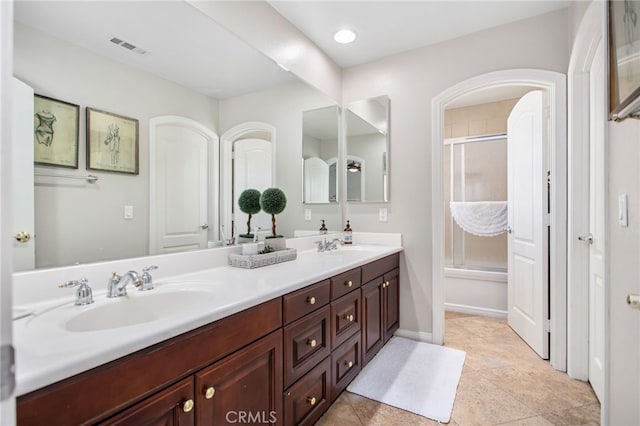 32429 Castle Ct, Temecula, CA 92592 - bathroom with double vanity and enclosed tub / shower combo