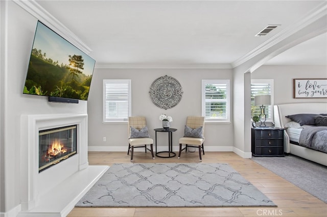 32429 Castle Ct, Temecula, CA 92592 - bedroom featuring ornamental molding, a glass covered fireplace, and wood finished floors
