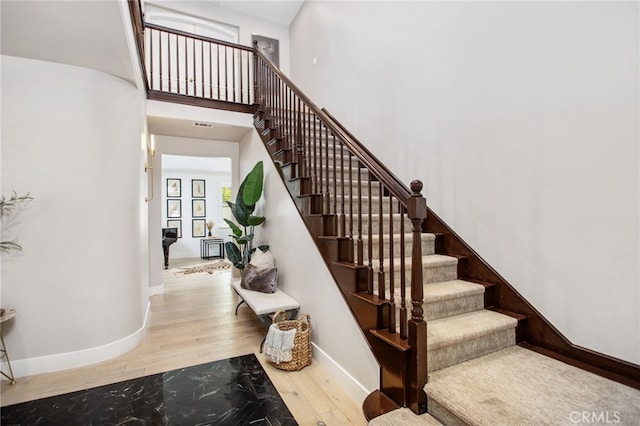 32429 Castle Ct, Temecula, CA 92592 - staircase with wood finished floors and a high ceiling