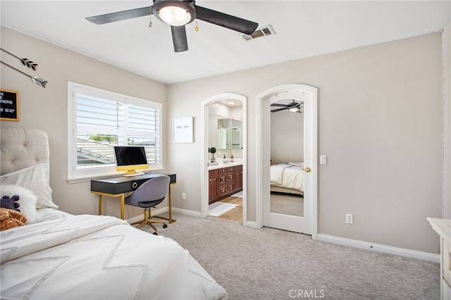 32429 Castle Ct, Temecula, CA 92592 - bedroom featuring light colored carpet, baseboards, ensuite bath, ceiling fan, and arched walkways