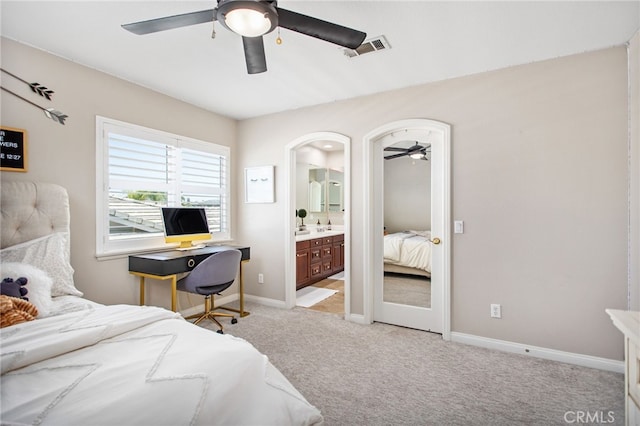 32429 Castle Ct, Temecula, CA 92592 - bedroom with light colored carpet, connected bathroom, a ceiling fan, and arched walkways