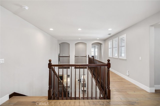 32429 Castle Ct, Temecula, CA 92592 - hallway featuring an upstairs landing, light wood-style floors, recessed lighting, and arched walkways