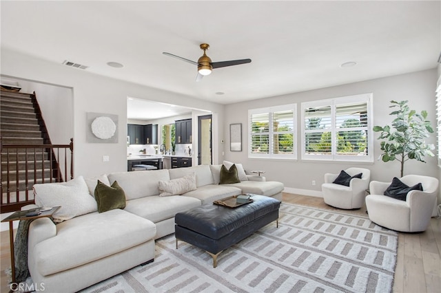32429 Castle Ct, Temecula, CA 92592 - living area with light wood-style floors, stairway, and a ceiling fan