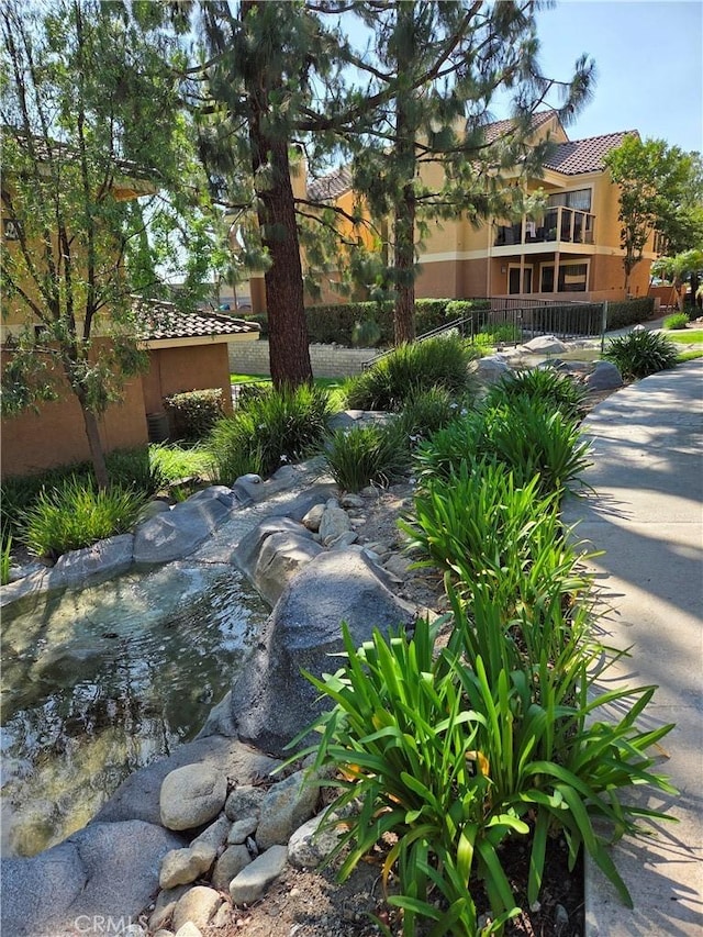 view of community featuring a small pond