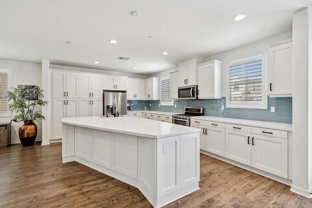 4203 Calle Del Vis, Oceanside, CA 92057 - kitchen featuring appliances with stainless steel finishes, white cabinetry, light countertops, tasteful backsplash, and recessed lighting